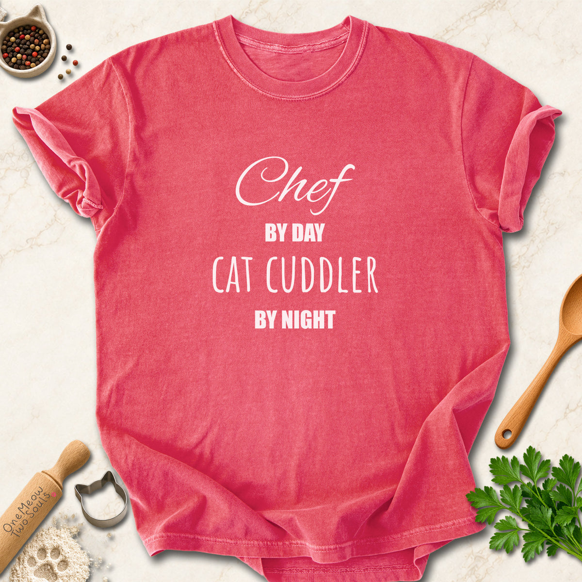 Watermelon colored Comfort Colors 1717 cotton T-shirt, featuring a "Chef by day, cat cuddler by night" funny cat design illustration. One Meow Two Souls brand.