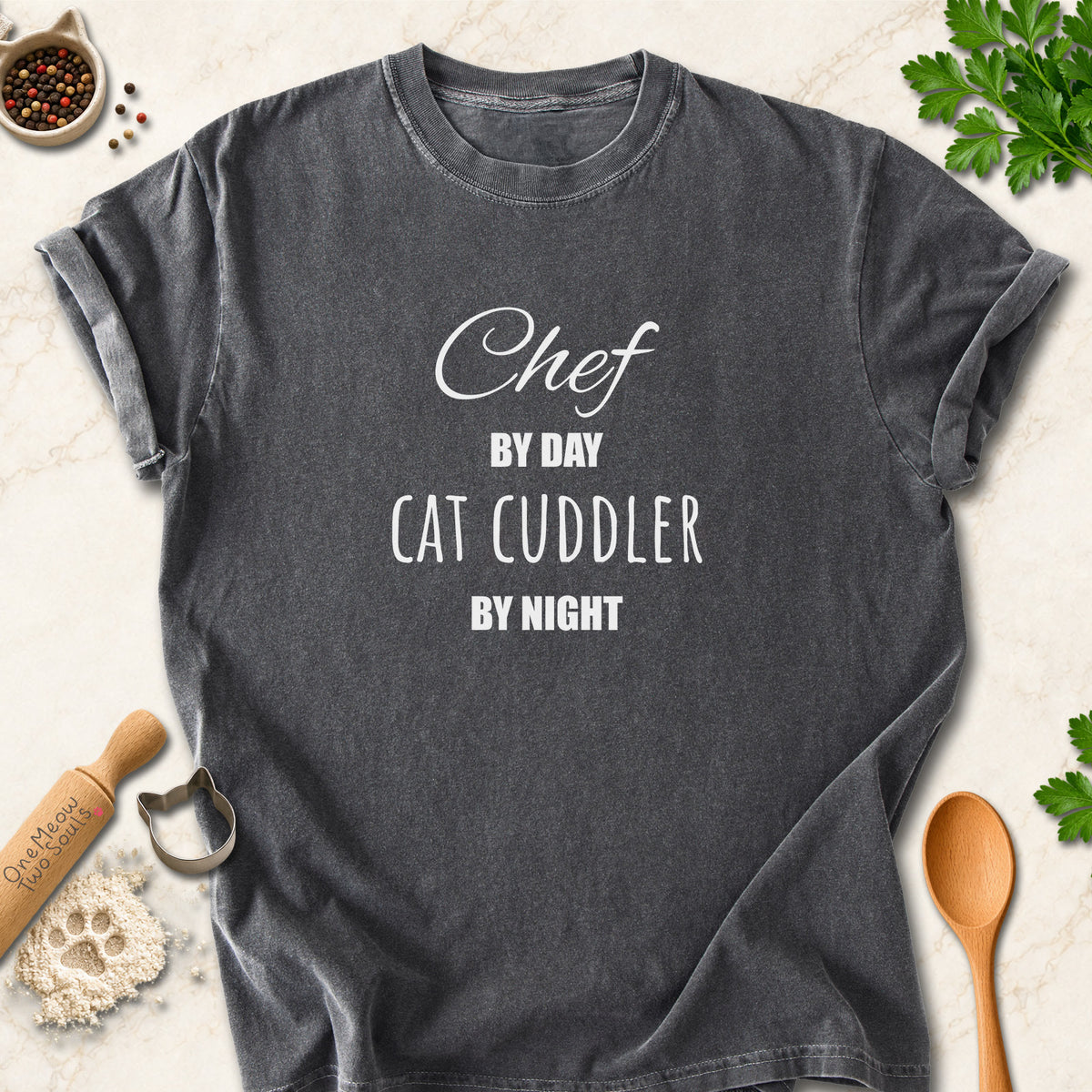 Pepper colored Comfort Colors 1717 cotton T-shirt, featuring a "Chef by day, cat cuddler by night" funny cat design illustration. One Meow Two Souls brand.