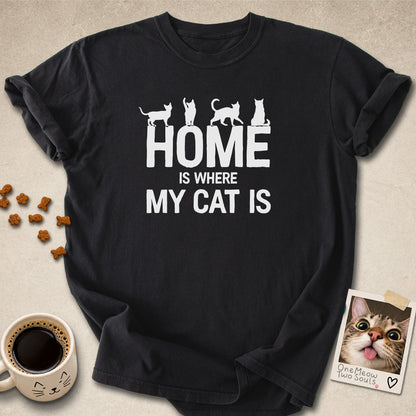 Black colored Comfort Colors 1717 cotton T-shirt, featuring a "Home is Where My Cat Is" funny cat design illustration. One Meow Two Souls brand.