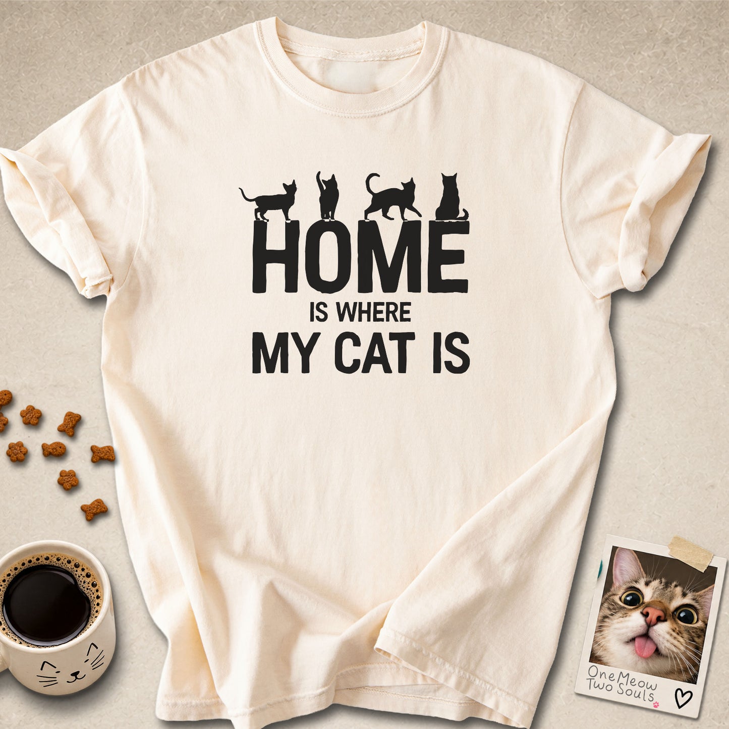 Ivory colored Comfort Colors 1717 cotton T-shirt, featuring a "Home is Where My Cat Is" funny cat design illustration. One Meow Two Souls brand.
