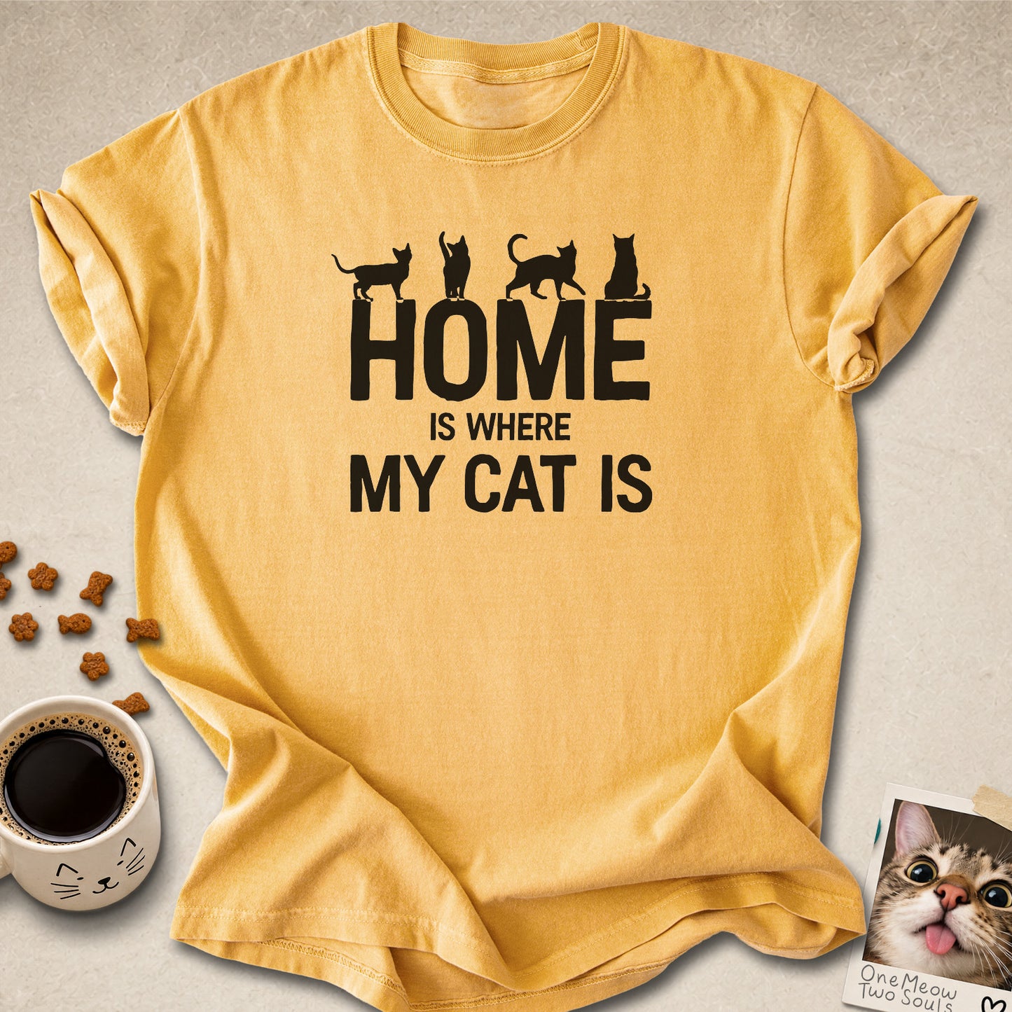Mustard colored Comfort Colors 1717 cotton T-shirt, featuring a "Home is Where My Cat Is" funny cat design illustration. One Meow Two Souls brand.
