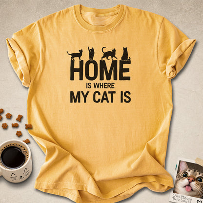 Mustard colored Comfort Colors 1717 cotton T-shirt, featuring a "Home is Where My Cat Is" funny cat design illustration. One Meow Two Souls brand.