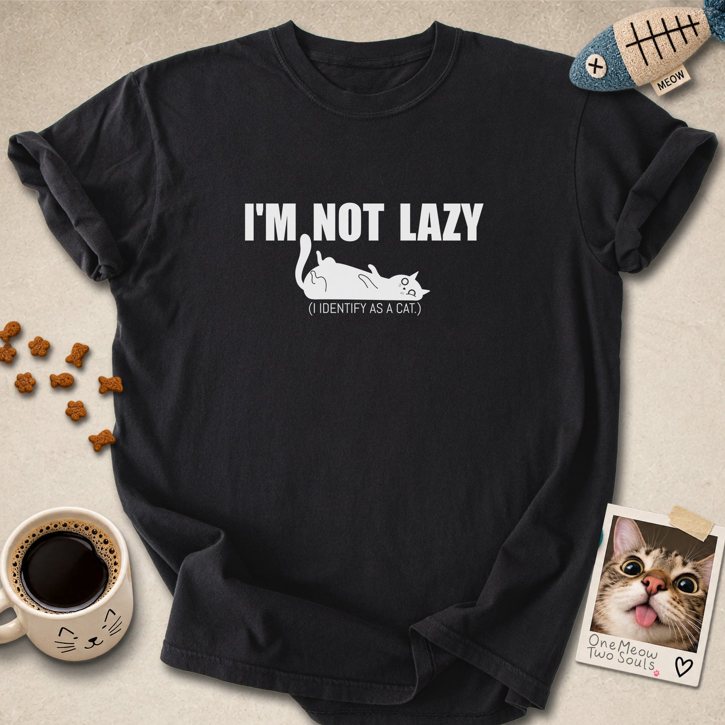 Black colored Comfort Colors 1717 cotton T-shirt, featuring a "I'm not lazy, I identify as a cat" funny cat design illustration. One Meow Two Souls brand.