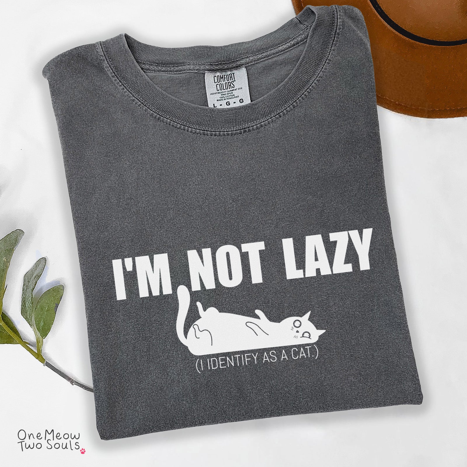 Pepper colored Comfort Colors 1717 cotton T-shirt, featuring a "I'm not lazy, I identify as a cat" funny cat design illustration. One Meow Two Souls brand.