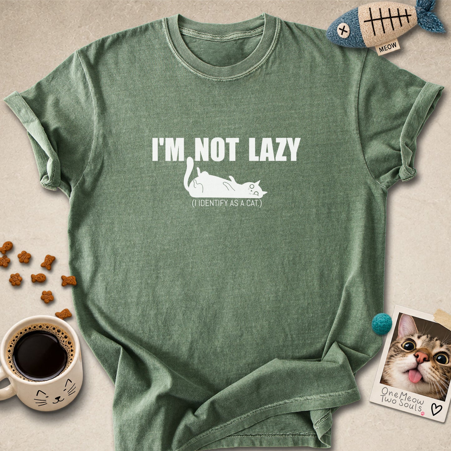 Moss colored Comfort Colors 1717 cotton T-shirt, featuring a "I'm not lazy, I identify as a cat" funny cat design illustration. One Meow Two Souls brand.
