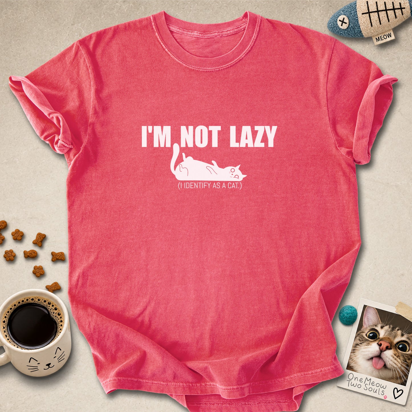 Watermelon colored Comfort Colors 1717 cotton T-shirt, featuring a "I'm not lazy, I identify as a cat" funny cat design illustration. One Meow Two Souls brand.