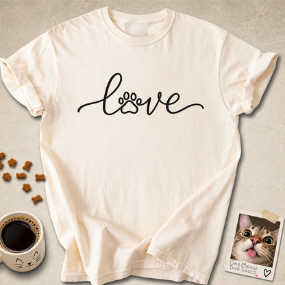 Ivory colored Comfort Colors 1717 cotton T-shirt, featuring a "LOVE" cat paw design illustration. One Meow Two Souls brand.