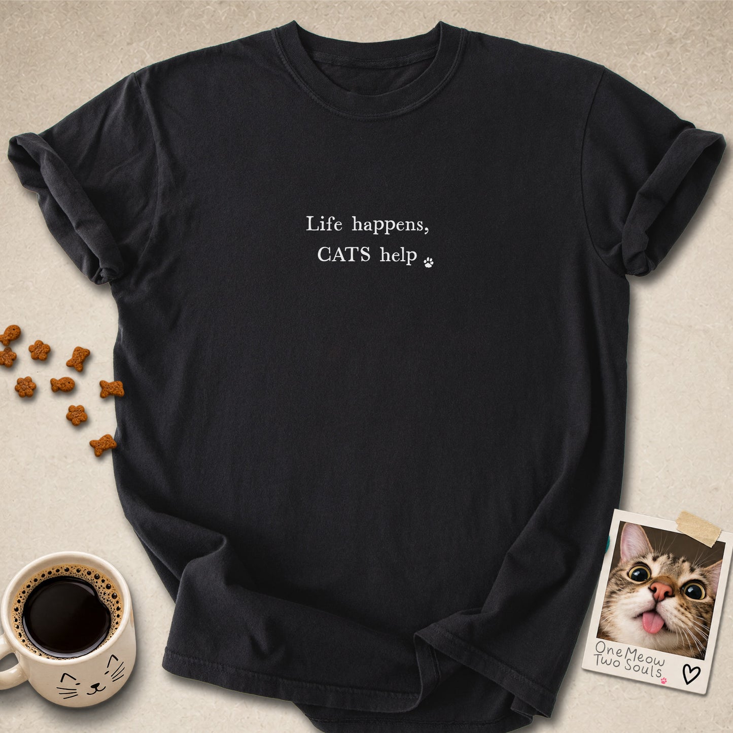 Black colored Comfort Colors 1717 cotton T-shirt, featuring a "Life happens, cats help" funny cat design illustration. One Meow Two Souls brand.