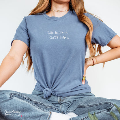 Blue jean colored Comfort Colors 1717 cotton T-shirt, featuring a "Life happens, cats help" funny cat design illustration. One Meow Two Souls brand.