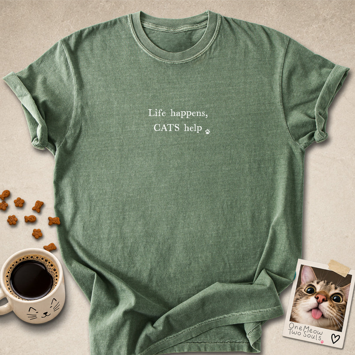 Moss colored Comfort Colors 1717 cotton T-shirt, featuring a "Life happens, cats help" funny cat design illustration. One Meow Two Souls brand.