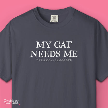 Pepper colored Comfort Colors 1717 cotton T-shirt, featuring a "My Cat Needs Me. The Emergency is Undisclosed" funny cat design illustration. One Meow Two Souls brand.