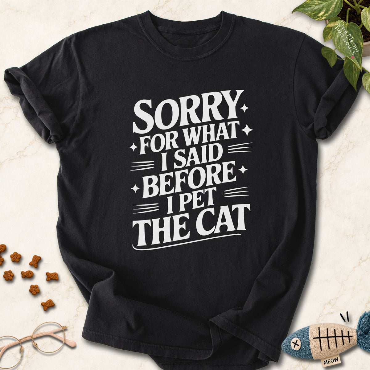 Black colored Comfort Colors 1717 cotton T-shirt, featuring a "Sorry for what I said before I pet the cat" funny cat design illustration. One Meow Two Souls brand.