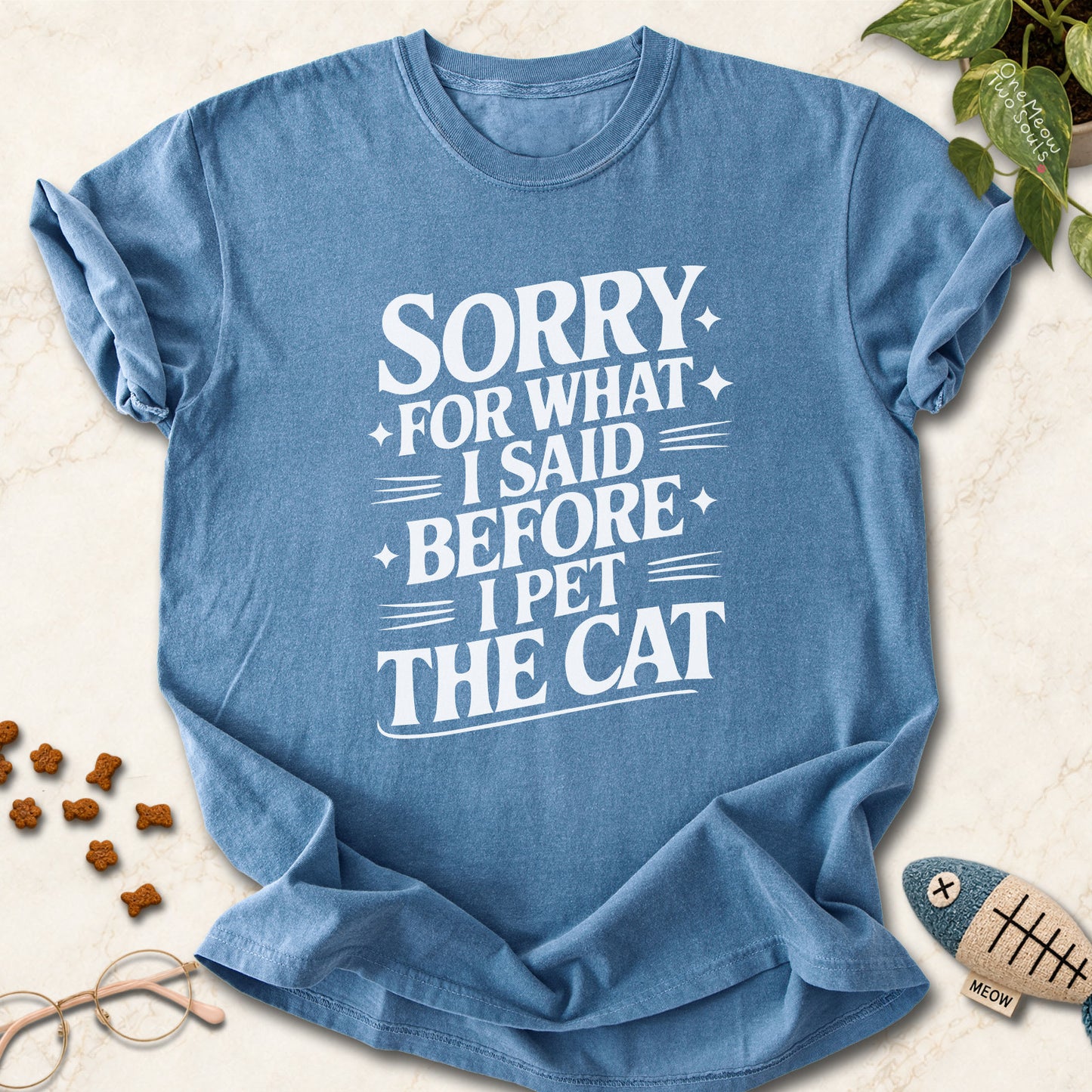 Blue Jean colored Comfort Colors 1717 cotton T-shirt, featuring a "Sorry for what I said before I pet the cat" funny cat design illustration. One Meow Two Souls brand.