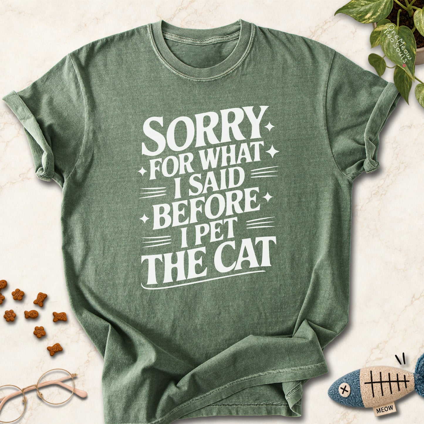 Moss colored Comfort Colors 1717 cotton T-shirt, featuring a "Sorry for what I said before I pet the cat" funny cat design illustration. One Meow Two Souls brand.