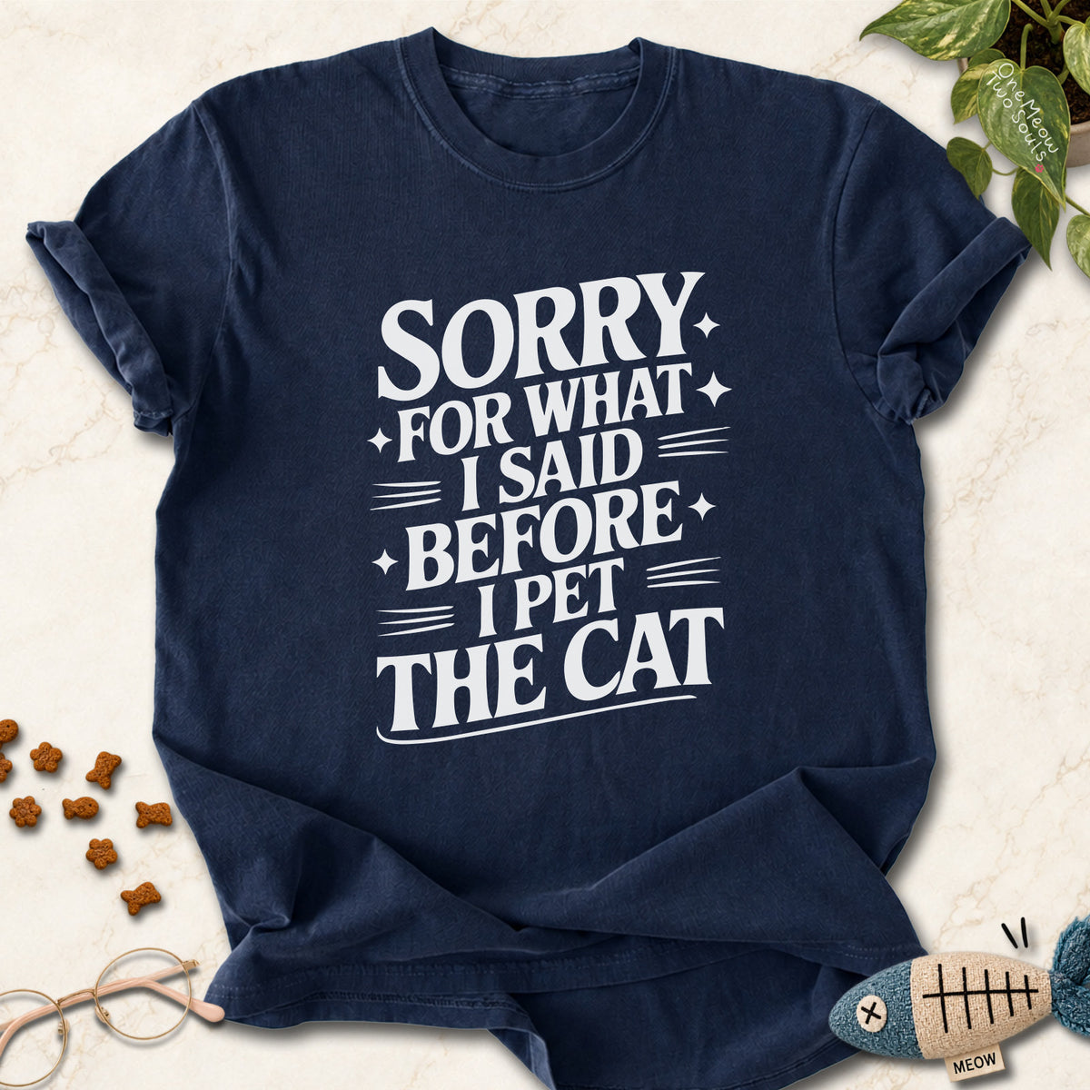 Navy colored Comfort Colors 1717 cotton T-shirt, featuring a "Sorry for what I said before I pet the cat" funny cat design illustration. One Meow Two Souls brand.