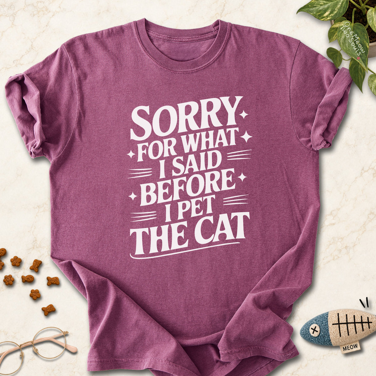 Berry colored Comfort Colors 1717 cotton T-shirt, featuring a "Sorry for what I said before I pet the cat" funny cat design illustration. One Meow Two Souls brand.