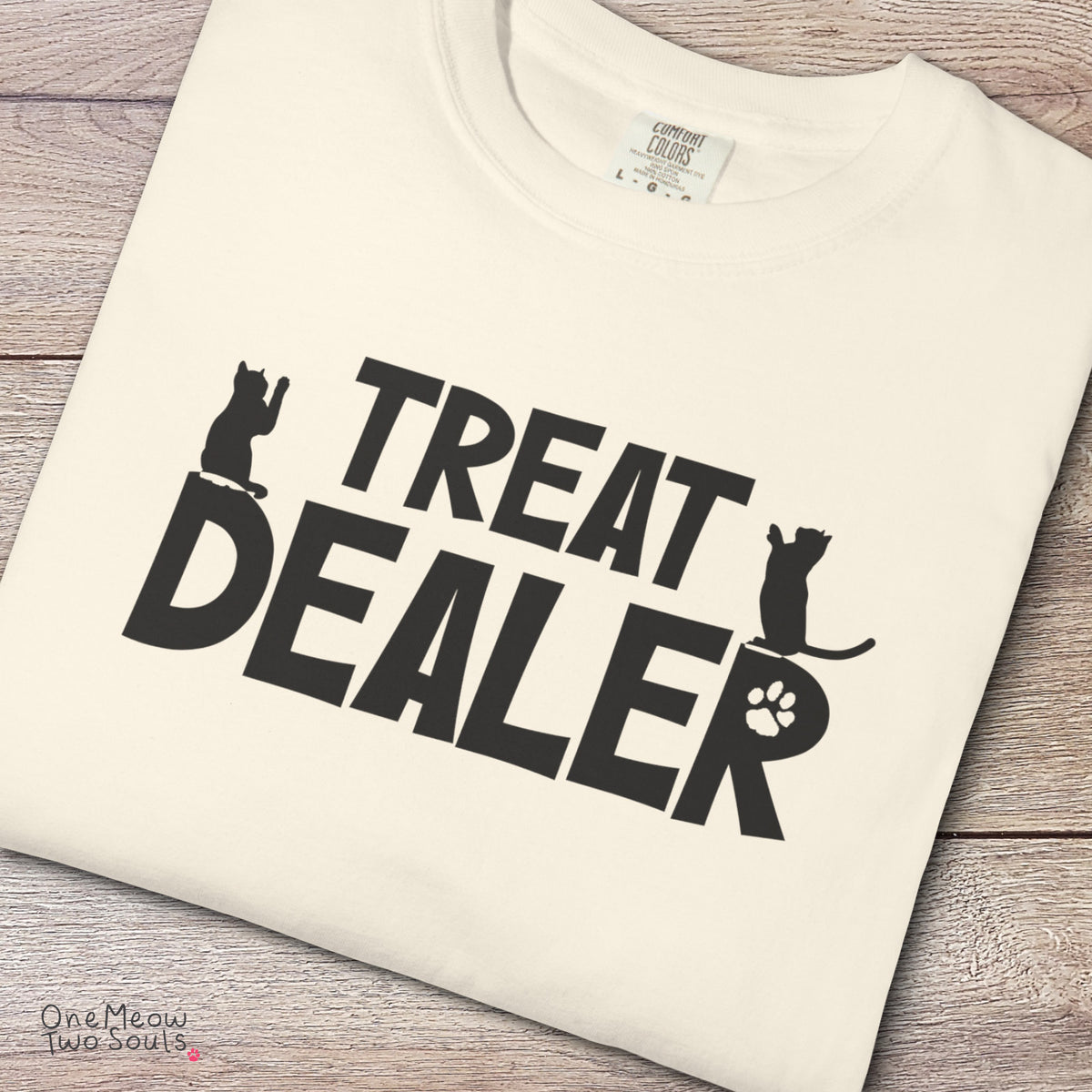 Ivory colored Comfort Colors 1717 cotton T-shirt, featuring a "Treat Dealer" funny cat design illustration. One Meow Two Souls brand.