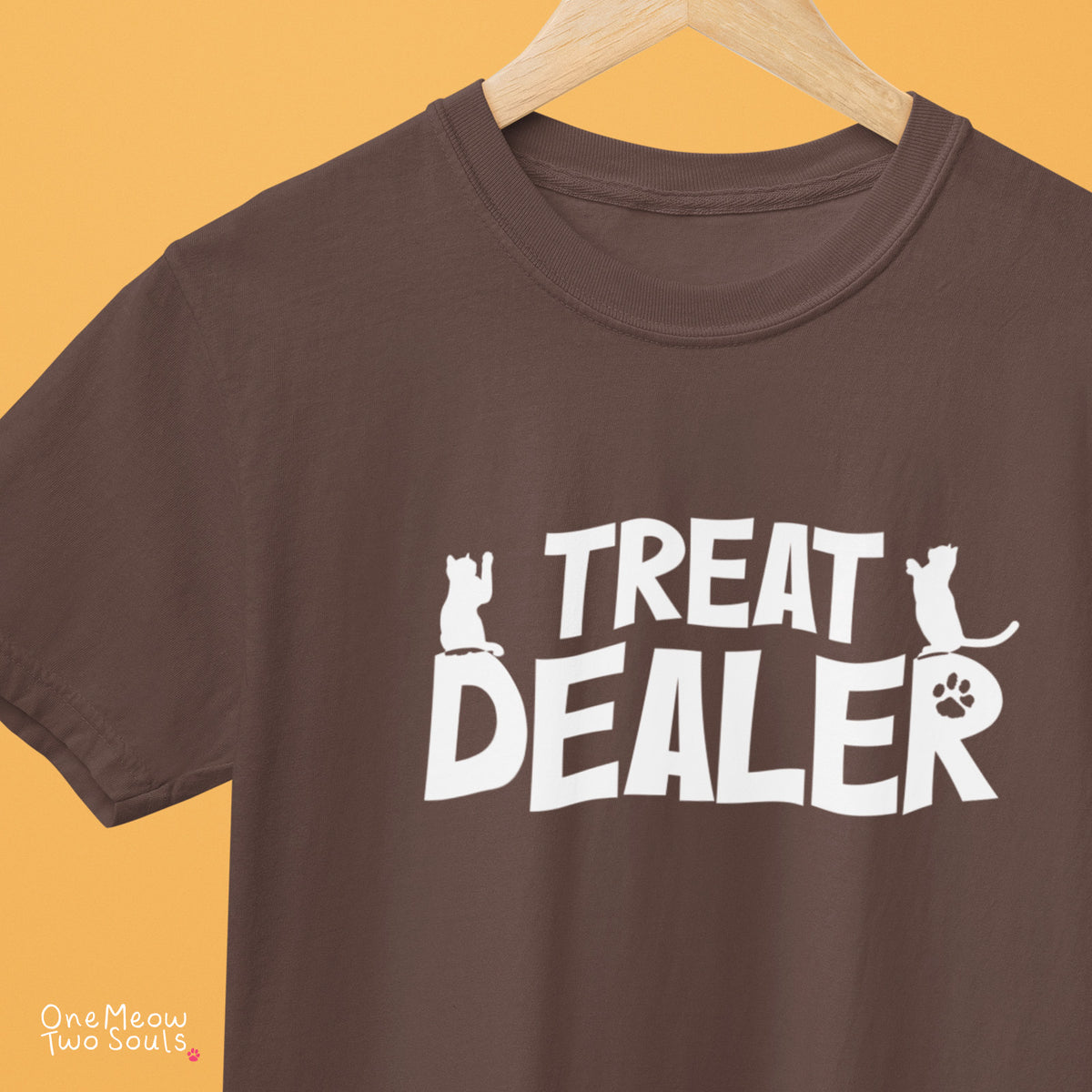 Espresso colored Comfort Colors 1717 cotton T-shirt, featuring a "Treat Dealer" funny cat design illustration. One Meow Two Souls brand.