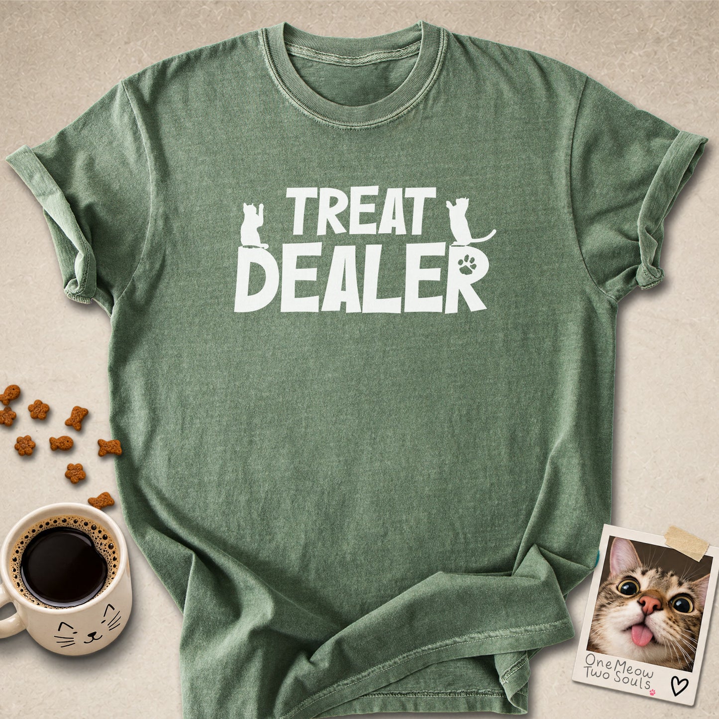 Moss colored Comfort Colors 1717 cotton T-shirt, featuring a "Treat Dealer" funny cat design illustration. One Meow Two Souls brand.