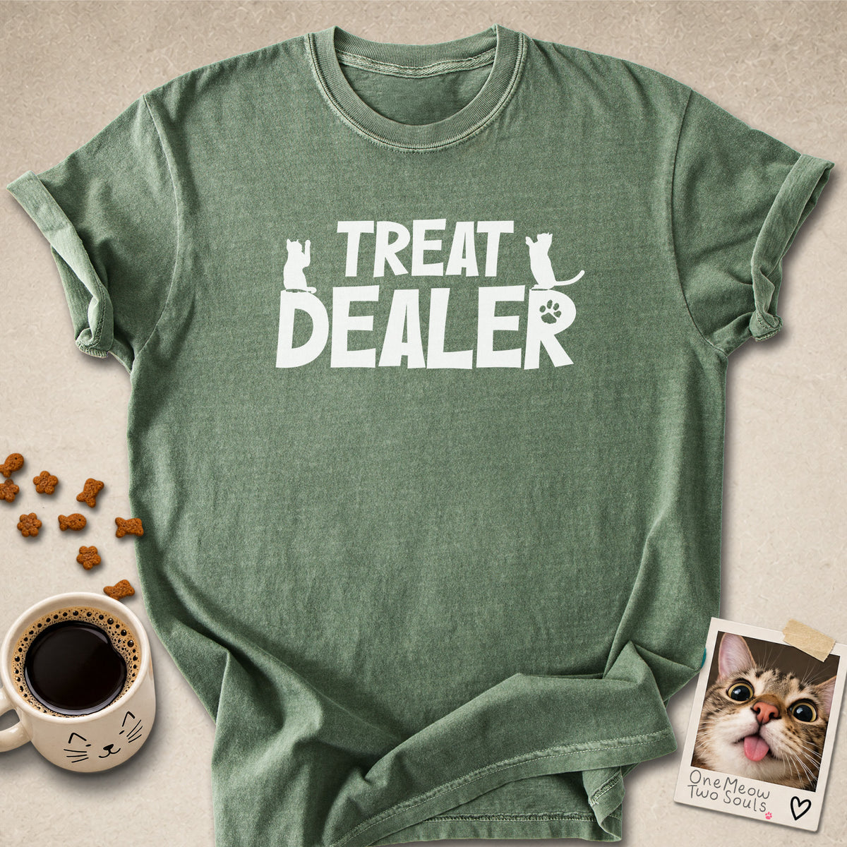 Moss colored Comfort Colors 1717 cotton T-shirt, featuring a "Treat Dealer" funny cat design illustration. One Meow Two Souls brand.