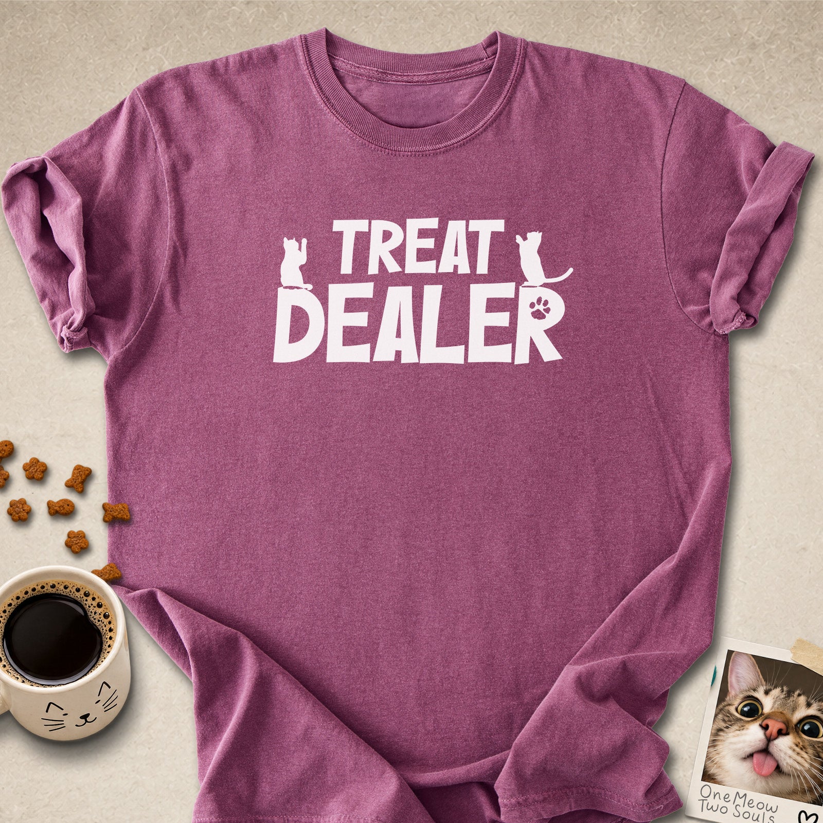 Berry colored Comfort Colors 1717 cotton T-shirt, featuring a "Treat Dealer" funny cat design illustration. One Meow Two Souls brand.