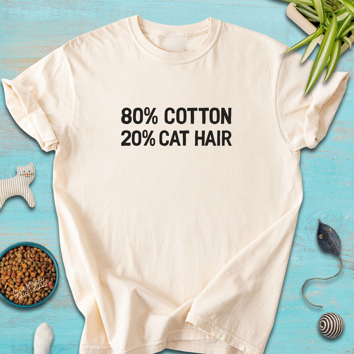 Ivory colored Comfort Colors 1717 t-shirt with a "80% cotton 20% cat hair" design. One Meow Two Souls brand.