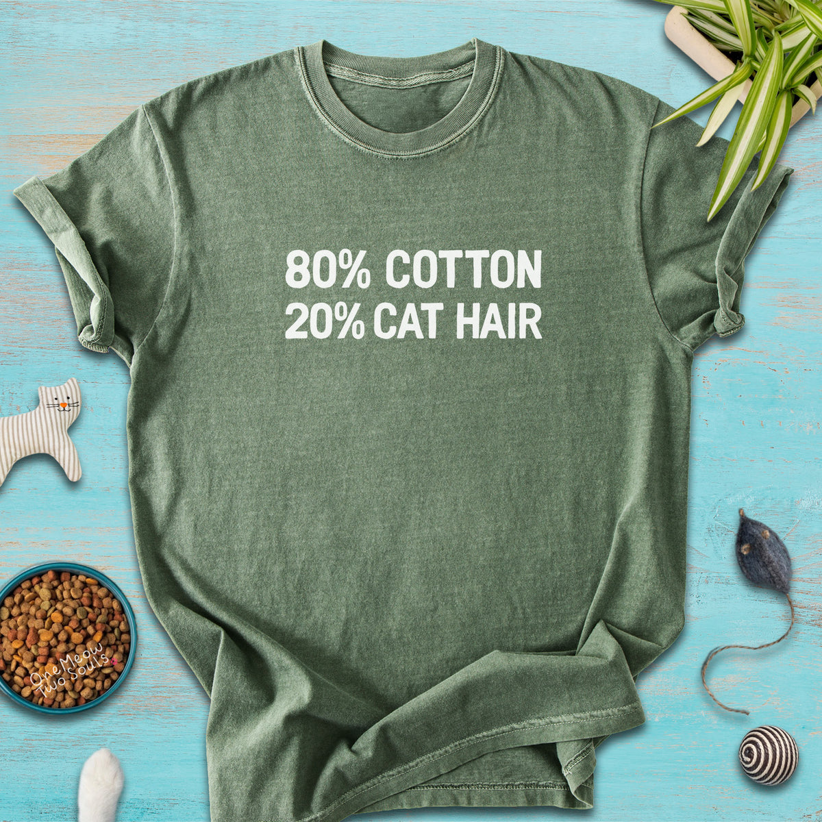 Moss colored Comfort Colors 1717 t-shirt with a "80% cotton 20% cat hair" design. One Meow Two Souls brand.