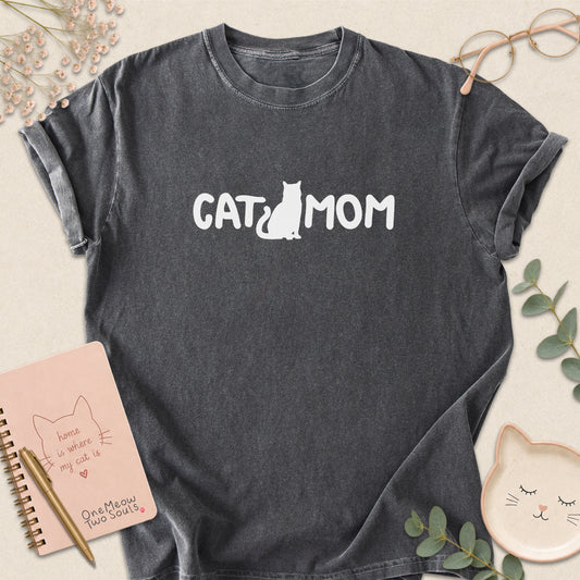 Pepper Comfort Colors 1717 t-shirt with a white graphic reading 'CAT MOM'. One Meow Two Souls brand.