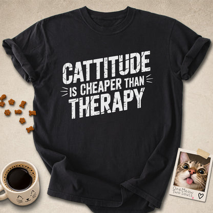 Black colored Comfort Colors 1717 cotton T-shirt, featuring a "Cattitude Is Cheaper Than Therapy" funny cat design illustration. One Meow Two Souls brand.