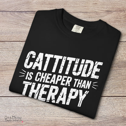 Black colored Comfort Colors 1717 cotton T-shirt, featuring a "Cattitude Is Cheaper Than Therapy" funny cat design illustration. One Meow Two Souls brand.