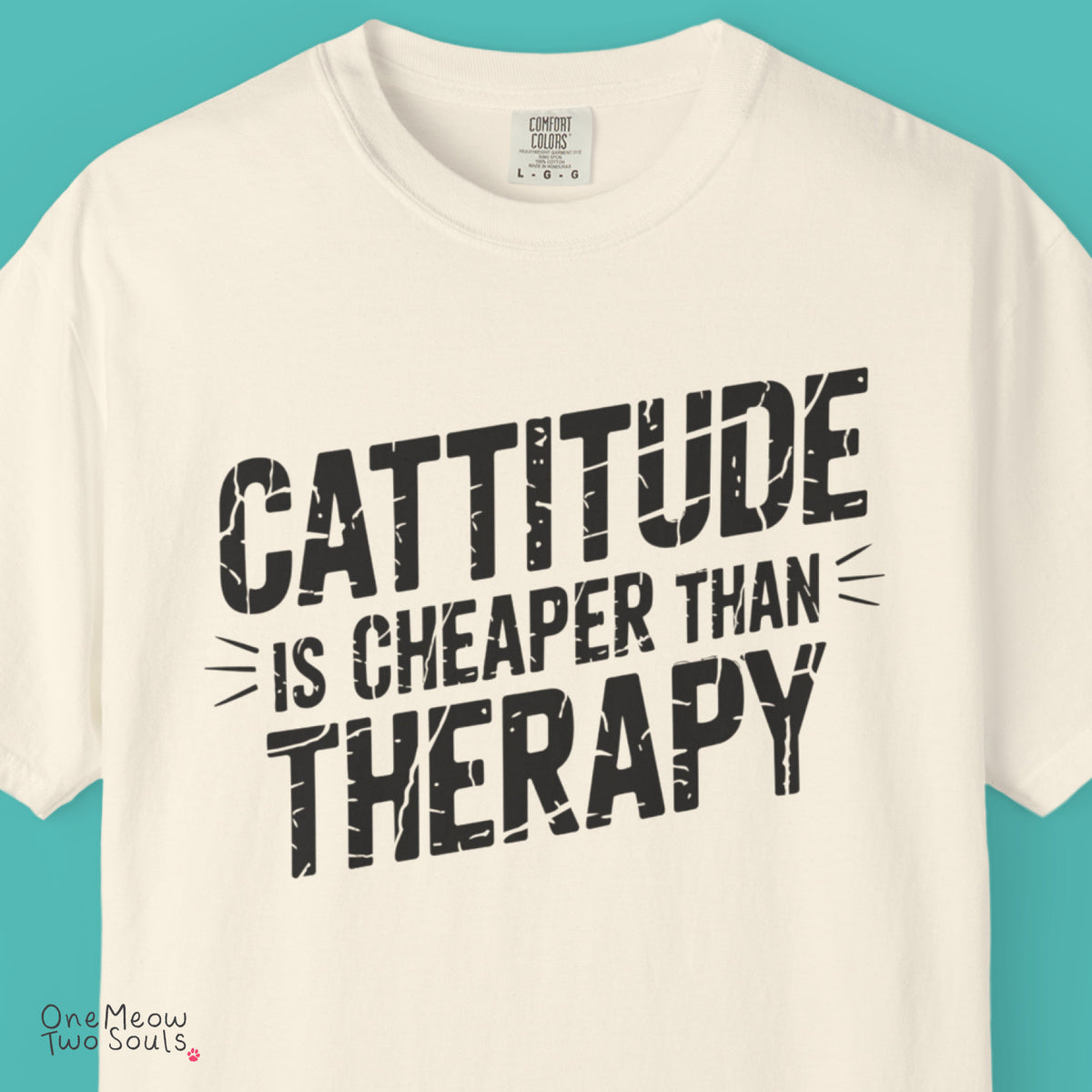 Ivory colored Comfort Colors 1717 cotton T-shirt, featuring a "Cattitude Is Cheaper Than Therapy" funny cat design illustration. One Meow Two Souls brand.