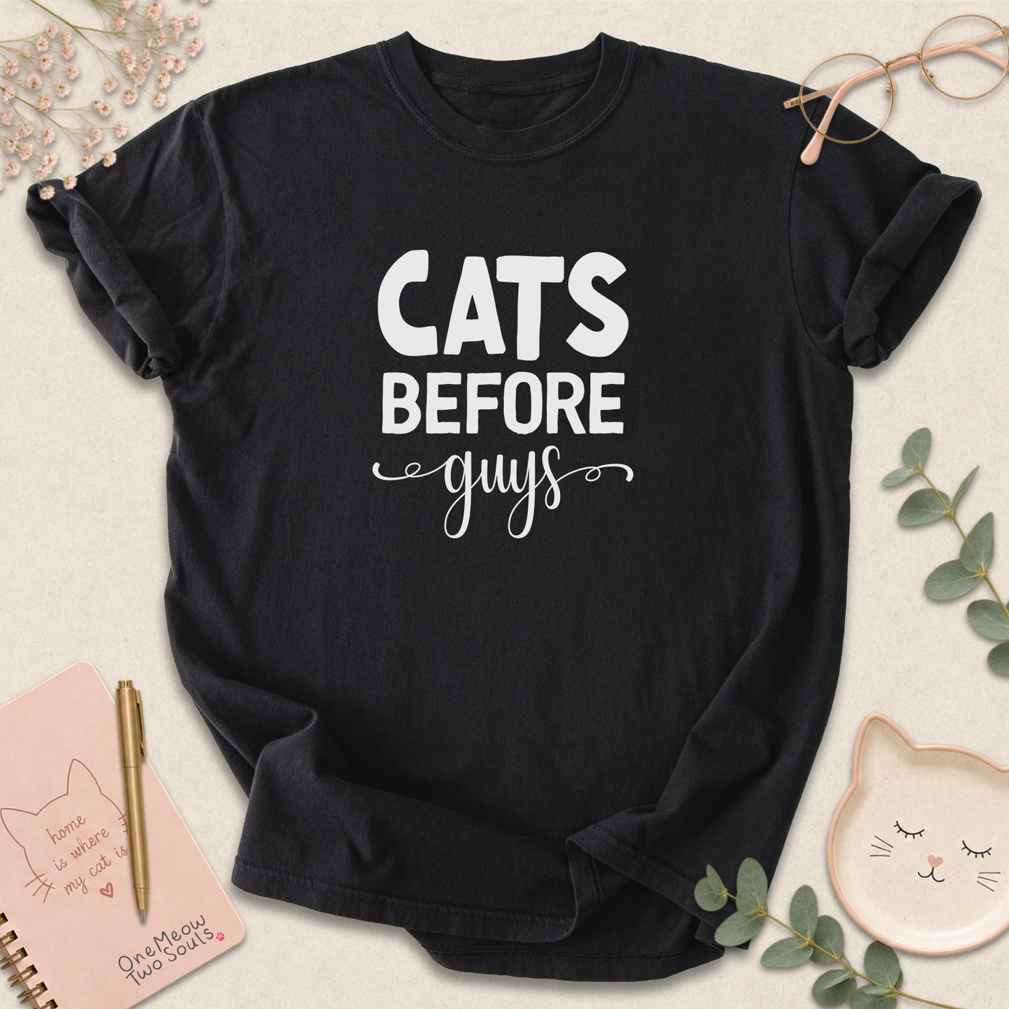 Black colored Comfort Colors 1717 cotton T-shirt, featuring a "Cats Before Guys" funny cat design illustration. One Meow Two Souls brand.