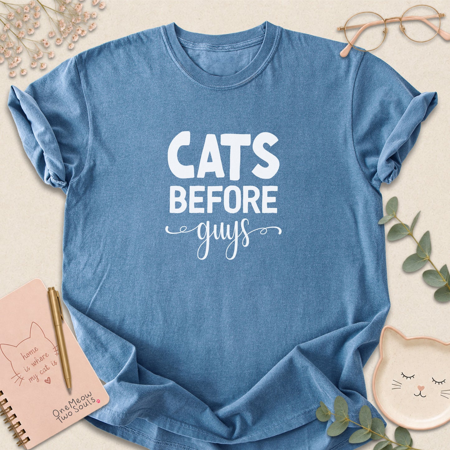 Blue jean colored Comfort Colors 1717 cotton T-shirt, featuring a "Cats Before Guys" funny cat design illustration. One Meow Two Souls brand.