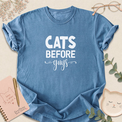 Blue jean colored Comfort Colors 1717 cotton T-shirt, featuring a "Cats Before Guys" funny cat design illustration. One Meow Two Souls brand.