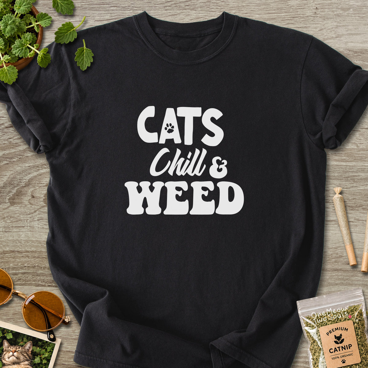 Black colored Comfort Colors 1717 cotton T-shirt, featuring a "Cats, Chill and Weed" funny cat design illustration. One Meow Two Souls brand.