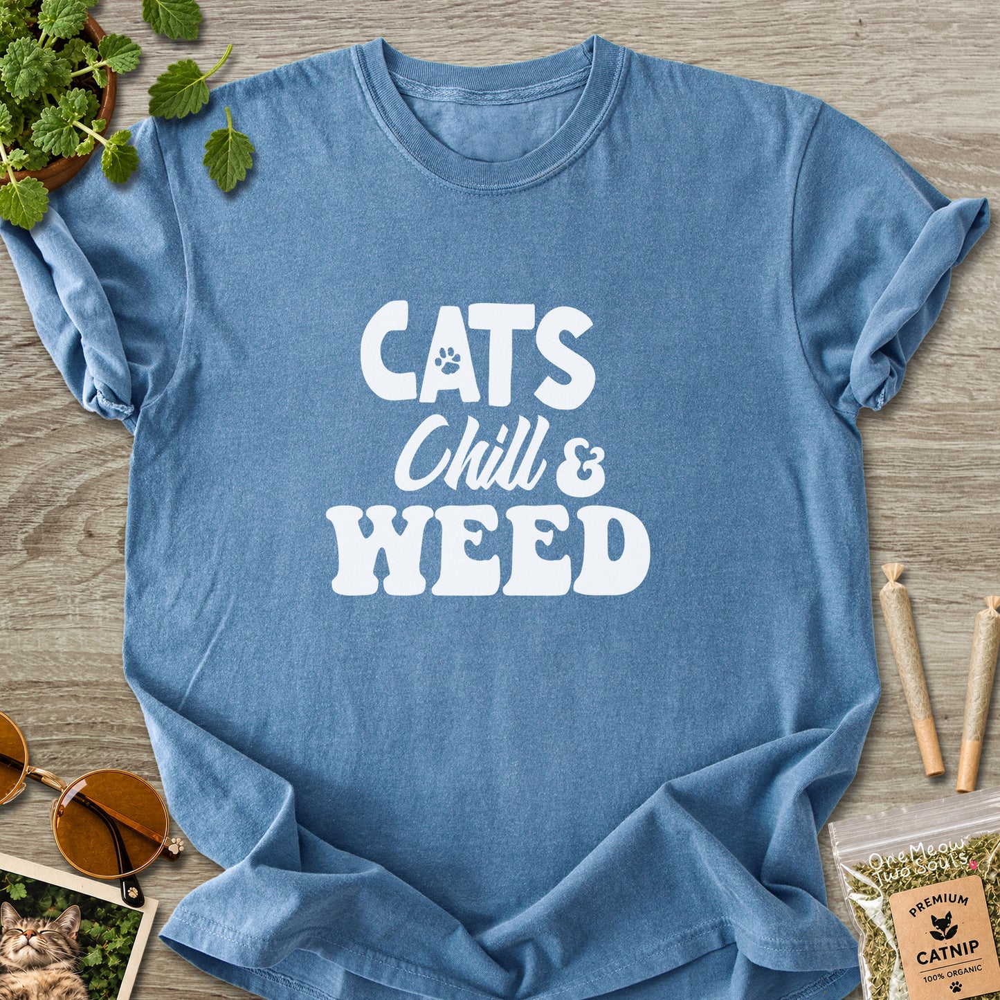 Blue jean colored Comfort Colors 1717 cotton T-shirt, featuring a "Cats, Chill and Weed" funny cat design illustration. One Meow Two Souls brand.
