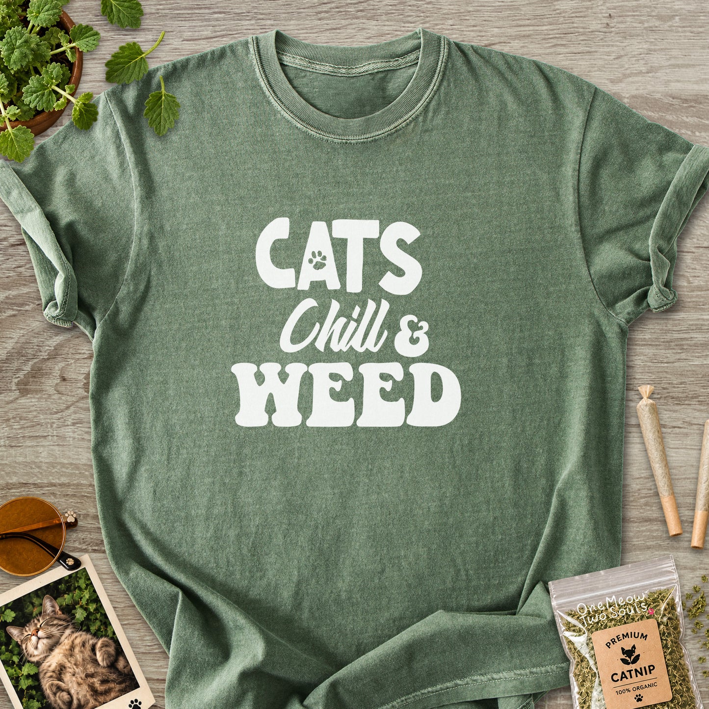 Moss colored Comfort Colors 1717 cotton T-shirt, featuring a "Cats, Chill and Weed" funny cat design illustration. One Meow Two Souls brand.
