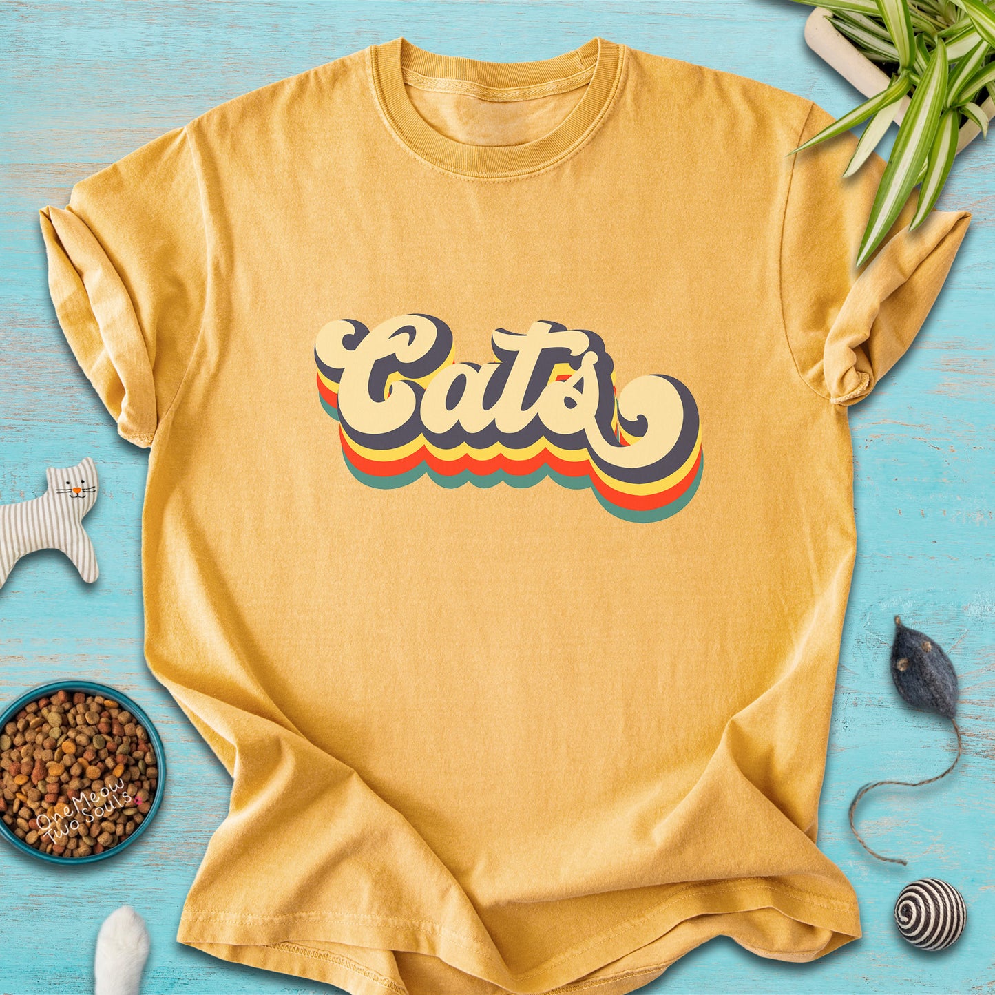 Mustard colored Comfort Colors 1717 t-shirt with a retro "Cats" typography design. Onw Meow Two Sould brand.