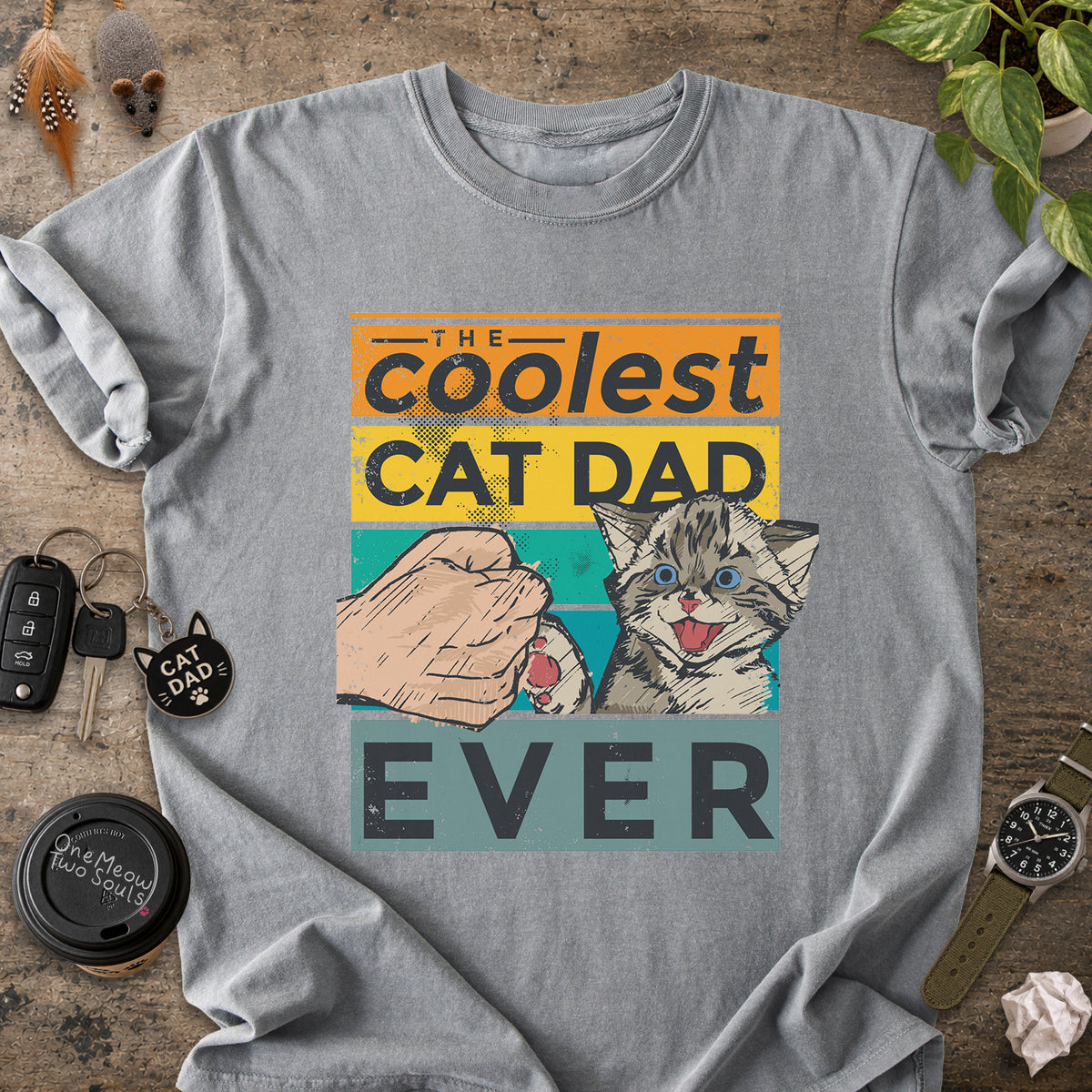 Grey colored Comfort Colors 1717 T-shirt with a "The Coolest Cat Dad Ever" colorful retro design. One Meow Two Souls brand.