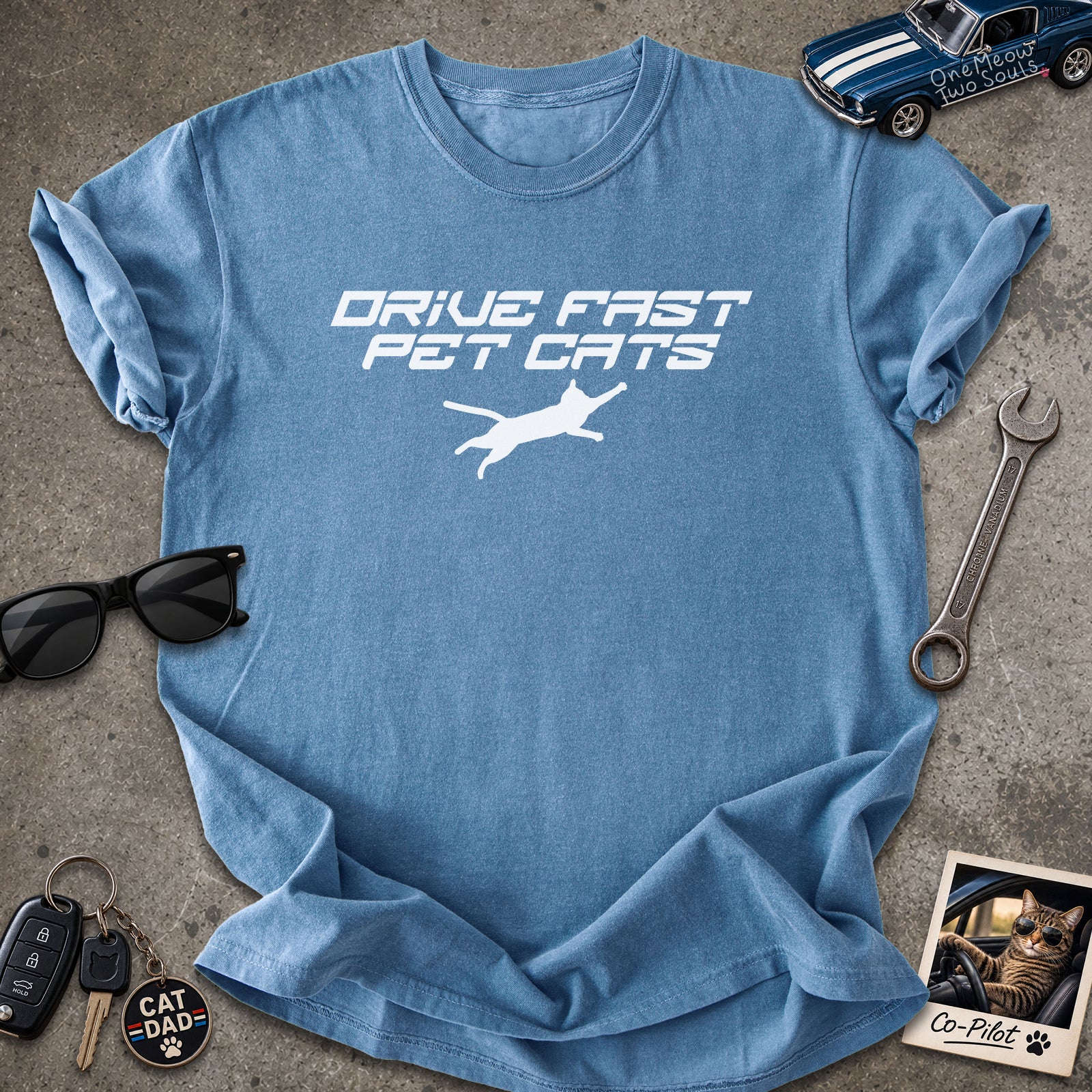 Blue Jean color Comfort Colors 1717 t-shirt with a "Drive Fast Pet Cats" design. Aimed for Cat dads and men who love cats. One Meow Two Souls brand.