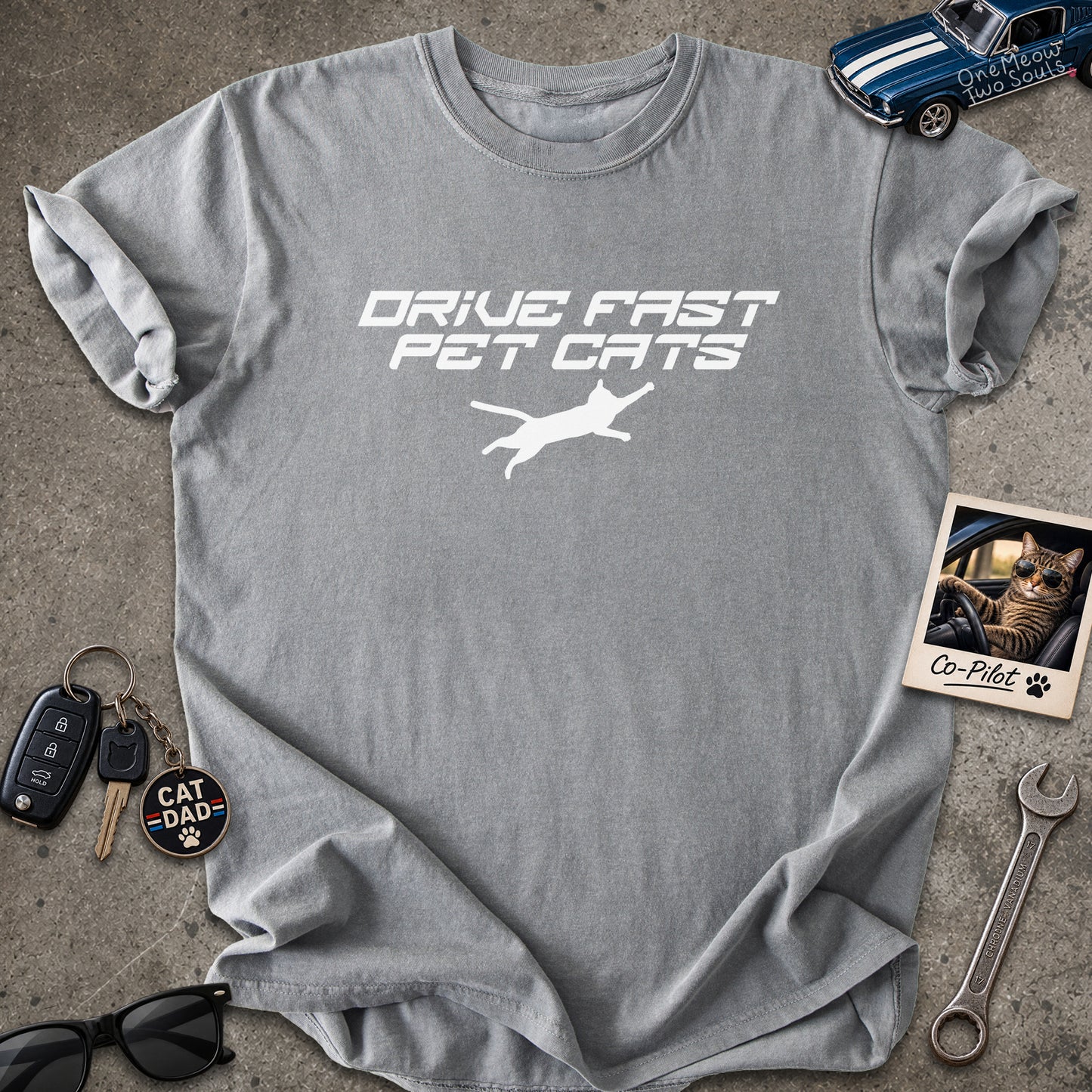Grey color Comfort Colors 1717 t-shirt with a "Drive Fast Pet Cats" design. Aimed for Cat dads and men who love cats. One Meow Two Souls brand.