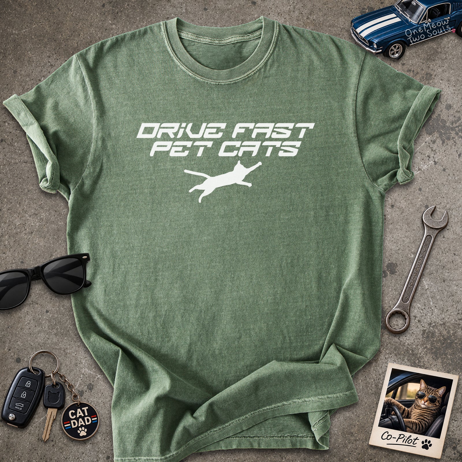 Moss color Comfort Colors 1717 t-shirt with a "Drive Fast Pet Cats" design. Aimed for Cat dads and men who love cats. One Meow Two Souls brand.