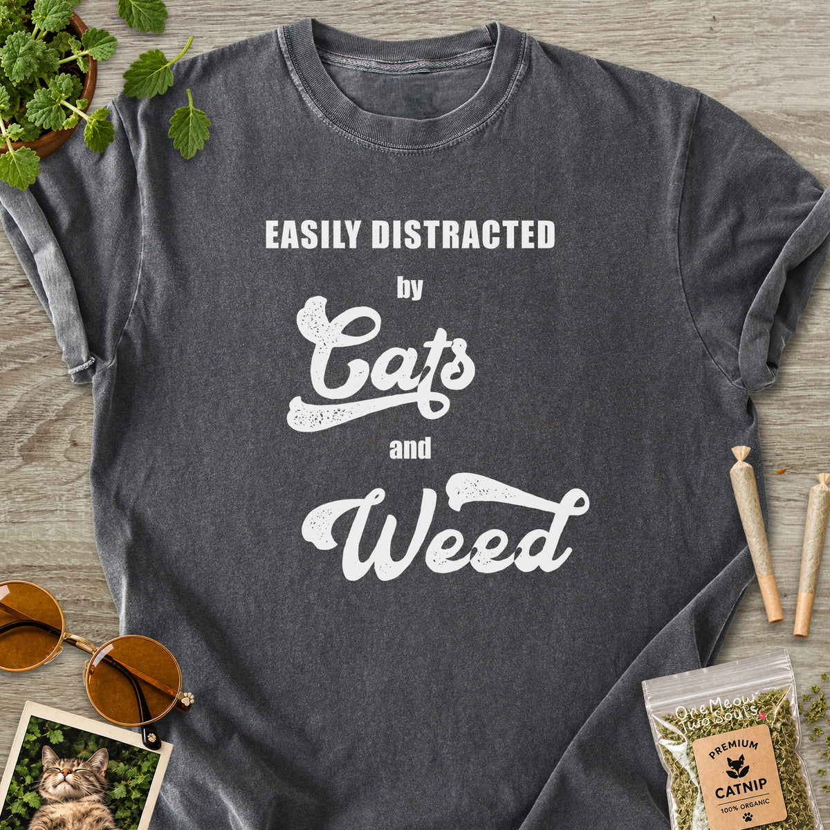 Pepper colored Comfort Colors 1717 cotton T-shirt, featuring a "Easily Distracted by Cats and Weed" funny cat design illustration. One Meow Two Souls brand.