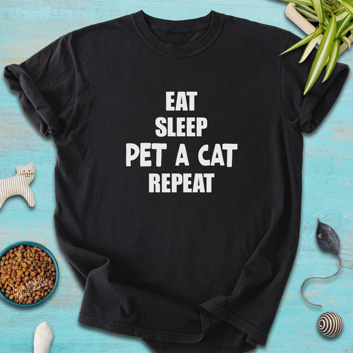 Black colored Comfort Colors 1717 t-cotton shirt with a "Eat Sleep Pet a Cat Repeat" design. One Meow Two Souls brand.