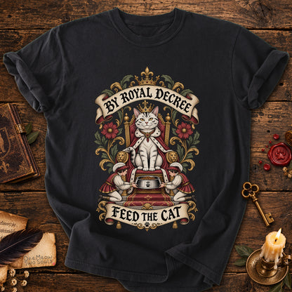 Black colored Comfort Colors 1717 cotton T-shirt, featuring a "By Royal Decree - Feed The Cat" funny cat design illustration. One Meow Two Souls brand.