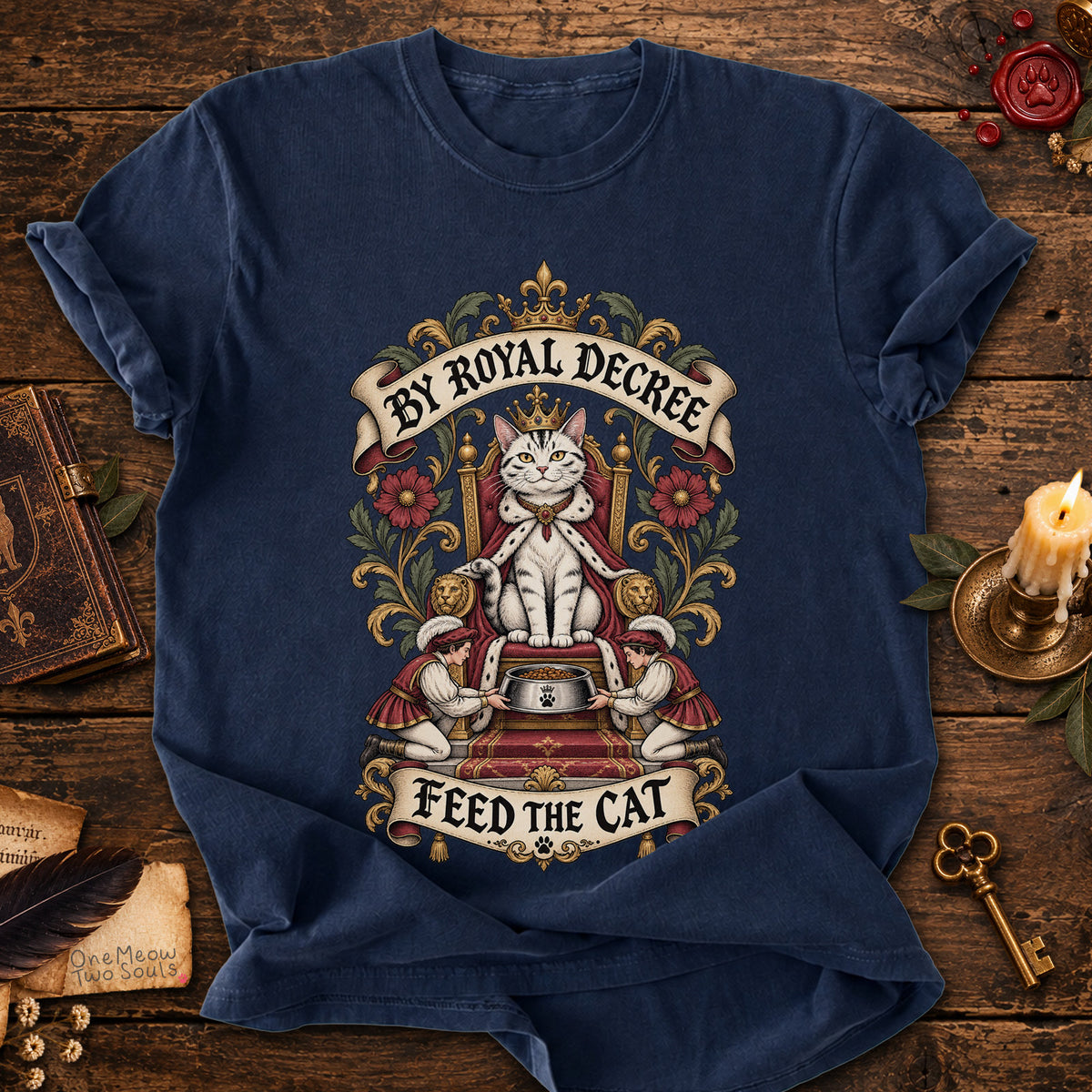 Navy colored Comfort Colors 1717 cotton T-shirt, featuring a "By Royal Decree - Feed The Cat" funny cat design illustration. One Meow Two Souls brand.
