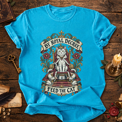 Sapphire colored Comfort Colors 1717 cotton T-shirt, featuring a "By Royal Decree - Feed The Cat" funny cat design illustration. One Meow Two Souls brand.