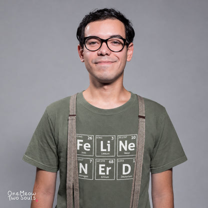 A man wearing glasses and a green t-shirt with a periodic table graphic spelling 'FELINE Nerd' in block letters, styled with suspenders against a solid gray background.
Moss color Comfort Colors 1717 T-shirt with a "Feline Nerd" chemitsry periodic table desigh. One Meow Two Souls brand.
