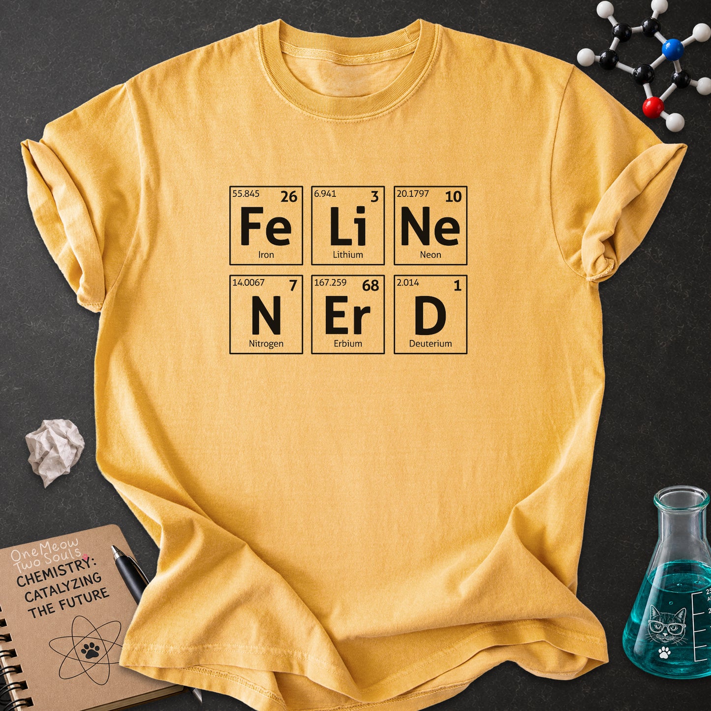 Mustard color Comfort Colors 1717 T-shirt with a "Feline Nerd" chemitsry periodic table desigh. One Meow Two Souls brand.