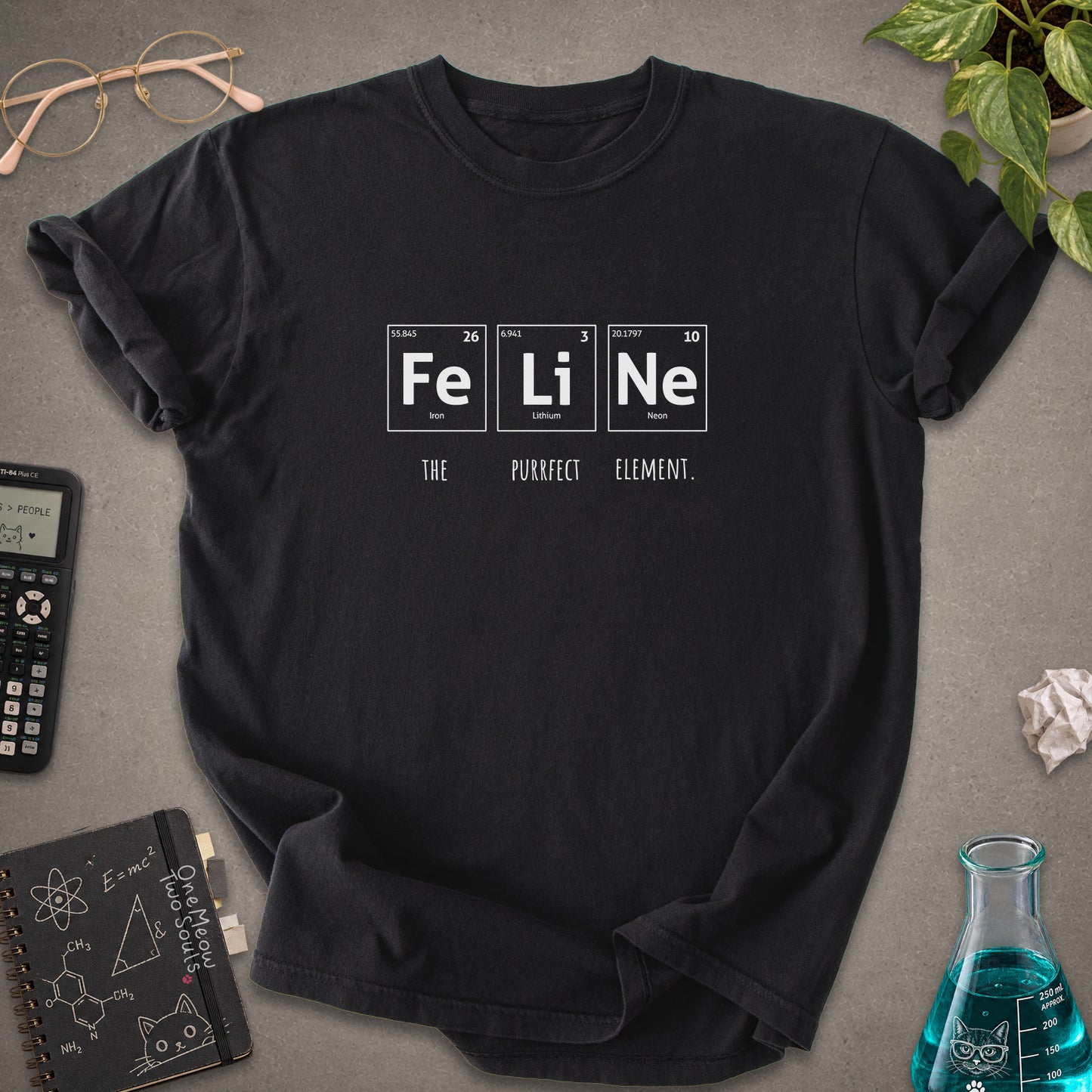 Black colored Comfort Colors 1717 cotton T-shirt, presenting a "FeLiNe The Purrfect Lelement" funny Chemistry cat design. One Meow Two Souls brand.